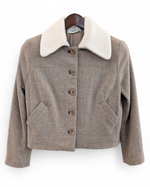 Brown jacket with white collar on a hanger against a white background