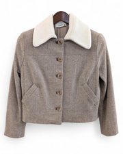 Brown jacket with white collar on a hanger against a white background